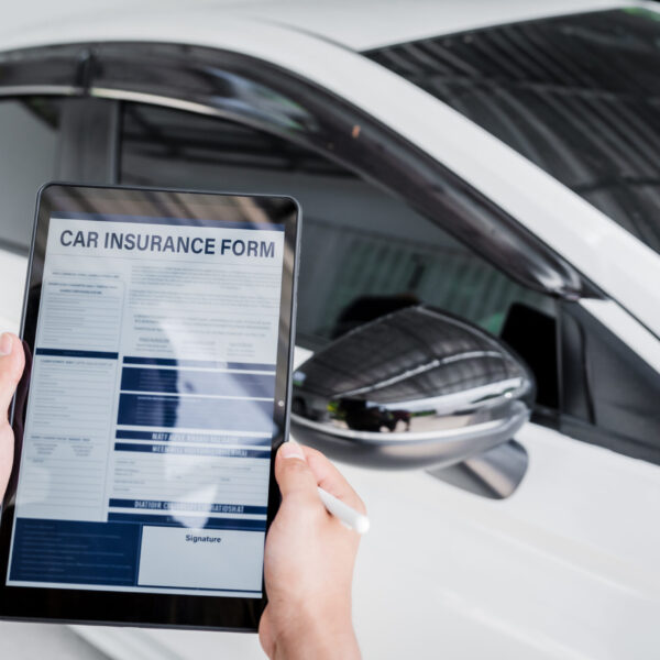 man-fills-out-a-car-insurance-form-after-a-car-acc-2025-03-09-01-49-15-utc
